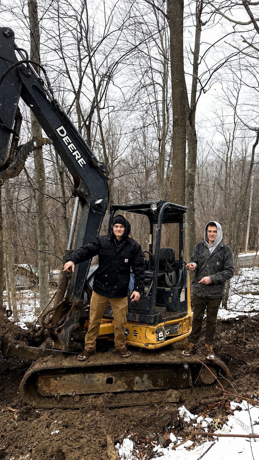 Ryan and Dennis standing on excavator during Twin Ridge Retreats perc testing